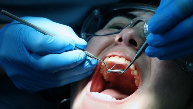 A customer is treated at a National Health Service (NHS) dental clinic in London
