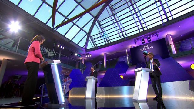 A wide shot showing host Mishal Husain, Keir Starmer and Rishi Sunak on the stage.