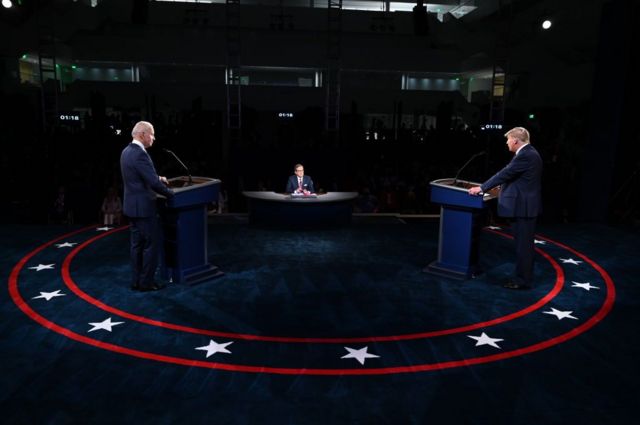 Donald Trump and Joe Biden stand behind podiums at the 2020 debate