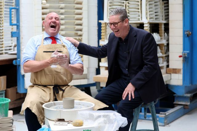 Keir Starmer shares a laugh with a potter sitting at a potter's wheel in Stoke