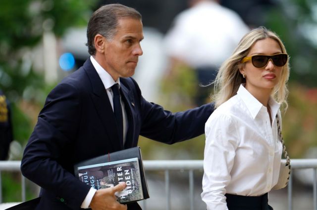 Hunter Biden walking behind his wife as they arrive at court in Delaware