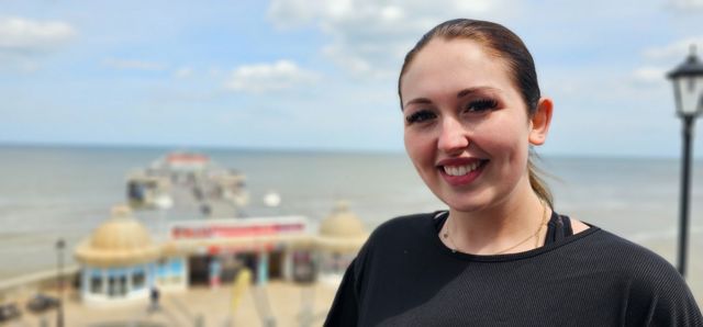 Charlotte Spendlove stands on the beachfront