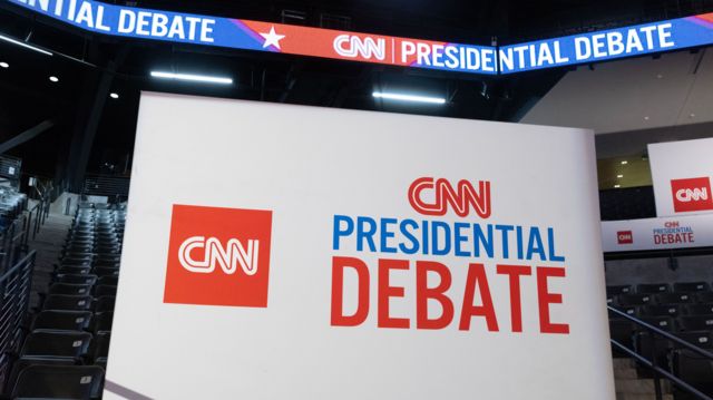 Signs are visible inside the spin room at Georgia Institute of Technology's McCamish Pavilion before the first 2024 presidential election debate between US President Joe Biden and former US President Donald J. Trump in Atlanta, Georgia