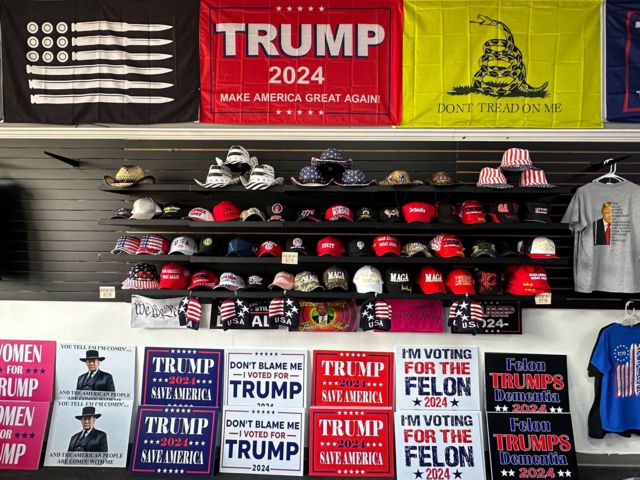 Trump merchandise including hats and signs