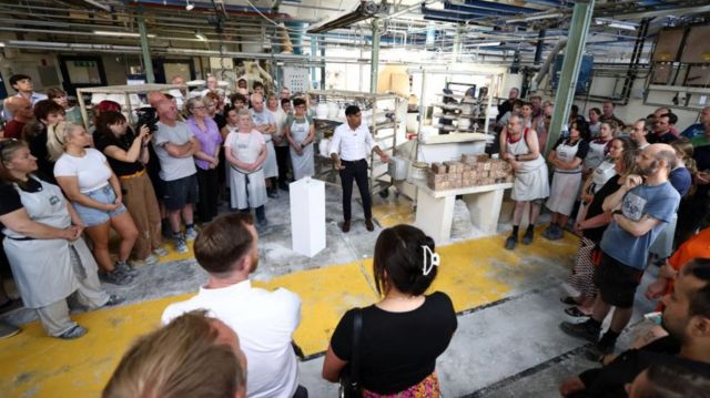Rishi Sunak standing on the factory floor speaking to staff during a visit to Denby Pottery Factory