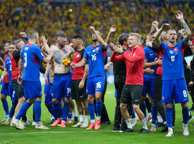 Slovakia players celebrate after drawing with Romania