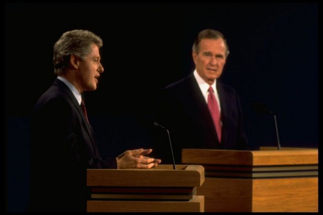 Bill Clinton speaks as President George H W Bush looks on during one of their 1992 campaign debates