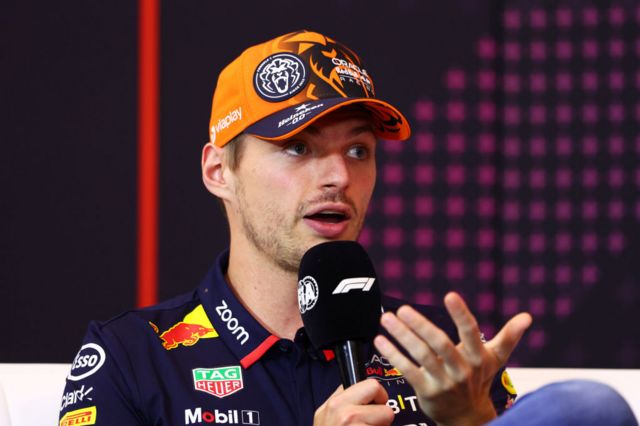 Max Verstappen holds a microphone in the Austrian Grand Prix press conference