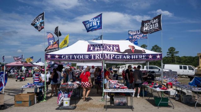 Trump supporters sell campaign merchandise at a rally in Virginia