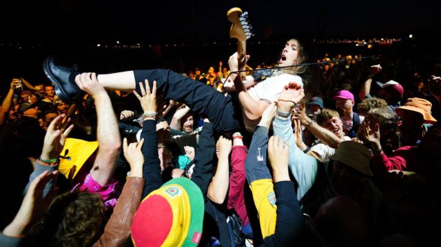 A guitarist from the Idles in the crowd while playing the Other Stage