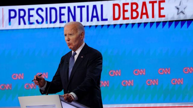 President Joe Biden motions on stage while answering a question during the debate