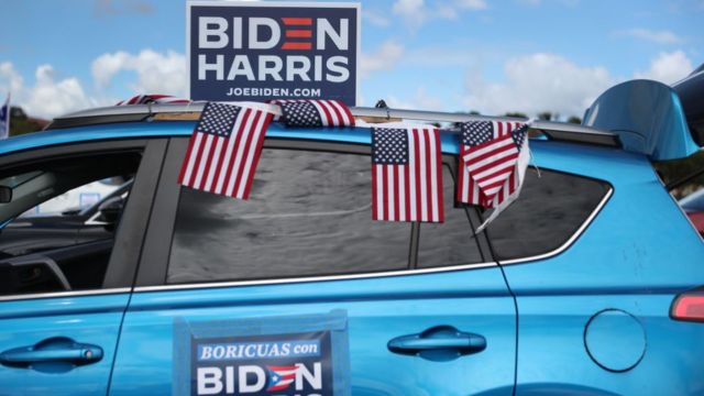 A vehicle is seen with campaign posters and American flags supporting Democratic presidential nominee Joe Biden