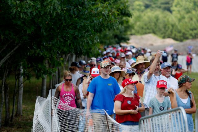 Trump supporters queue to get into a campaign rally in Virginia