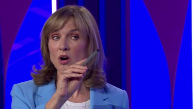 Fiona Bruce asking a question, pointing a pen