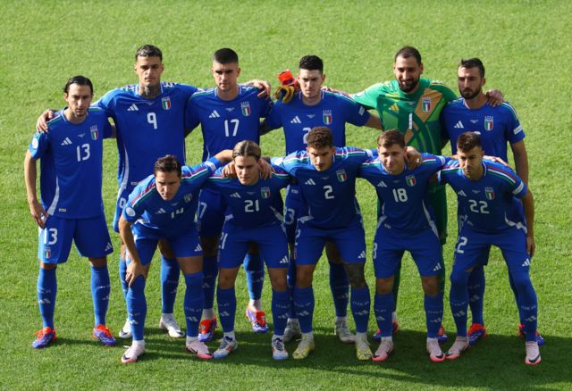 Italy players pose for a team group photo before the match