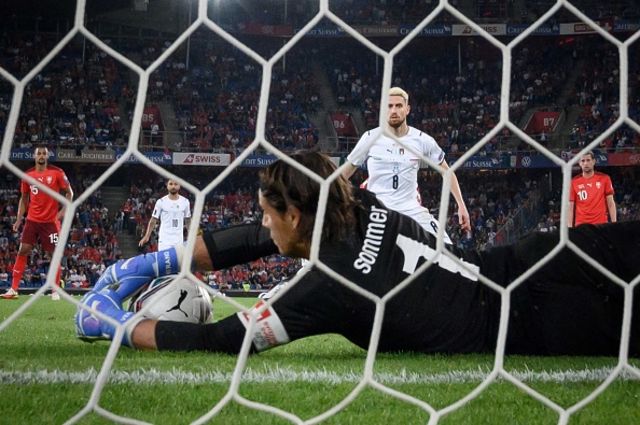 Yann Sommer saves a penalty kicked by Italy's midfielder Jorginho