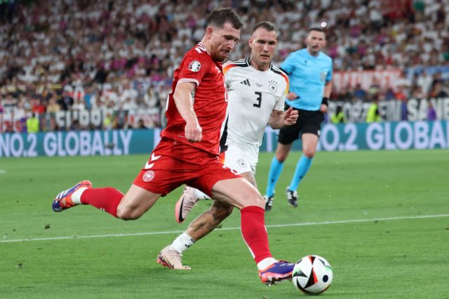Pierre-Emile Hojbjerg of Denmark (L) in action against David Raum of Germany