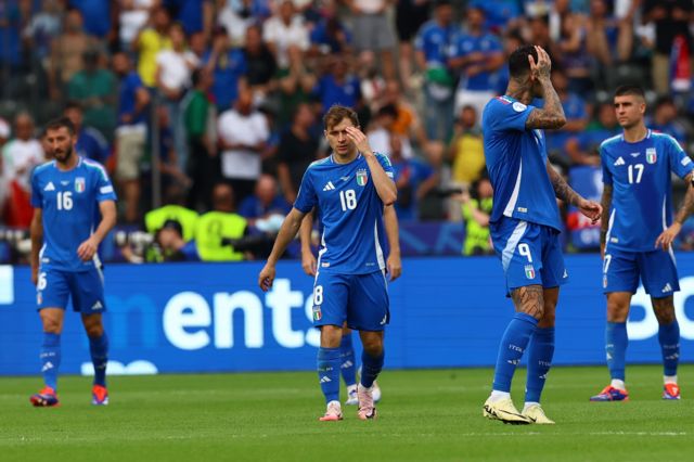 Players of Italy look disappointed after conceding the 2-0 goal during the UEFA EURO 2024 Round of 16 soccer match between Switzerland and Italy, in Berlin, Germany
