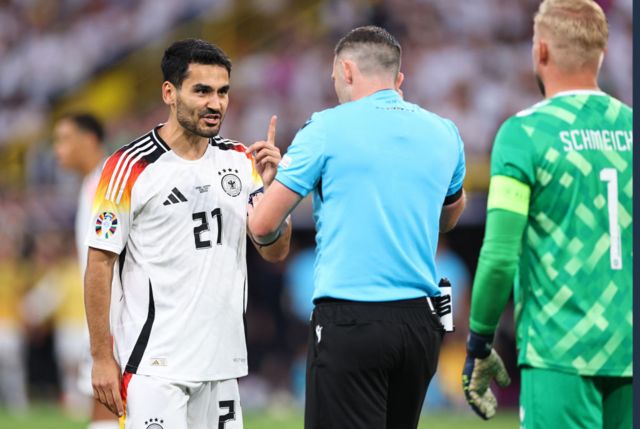 Germany's captain Ilkay Gundogan protests to Referee Michael Oliver about decison