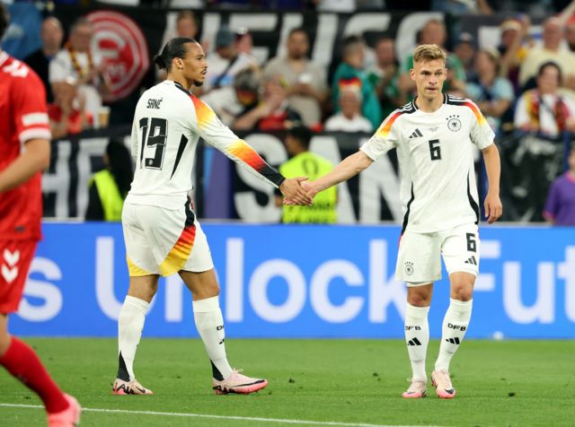 Joshua Kimmich of Germany (R) reacts with Leroy Sane of Germany