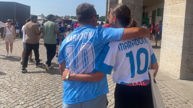 Man and woman in Maradona shirts