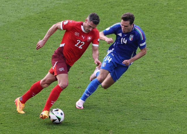 Fabian Schaer of Switzerland (L) and Federico Chiesa of Italy in action