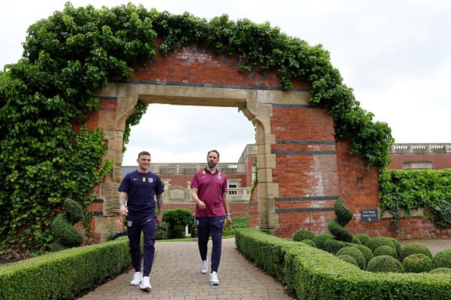 Kieran Trippier interacts with Gareth Southgate following a training session at Rockliffe Park