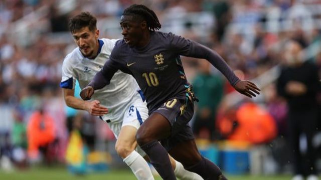 Eberechi Eze of England runs with the ball under pressure from Armin Gigovic