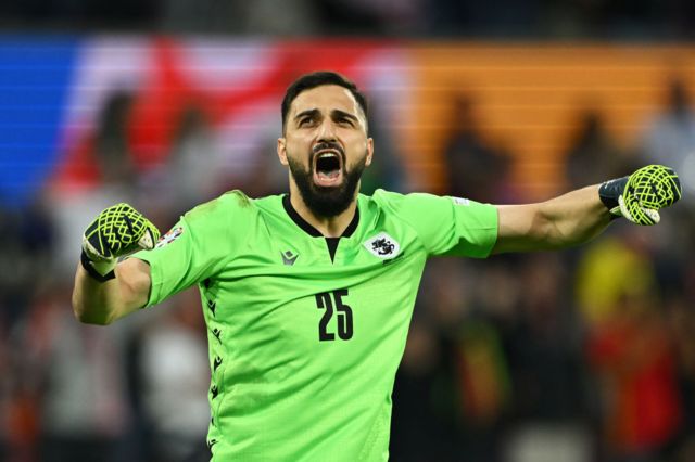 Giorgi Mamardashvili punches the air to celebrate Georgia scoring a goal