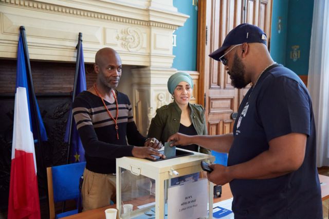 A French citizen casts a ballot at a polling station in Saint Denis, a diverse suburb in the northern part of Paris on 30 June 2024 in Paris, France