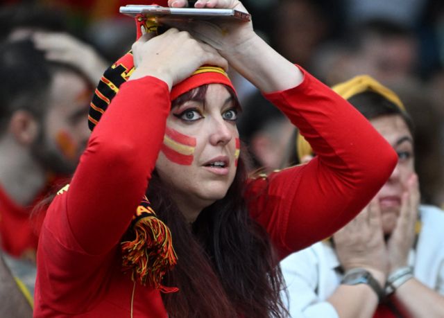 A Spain fan puts her hands on her head