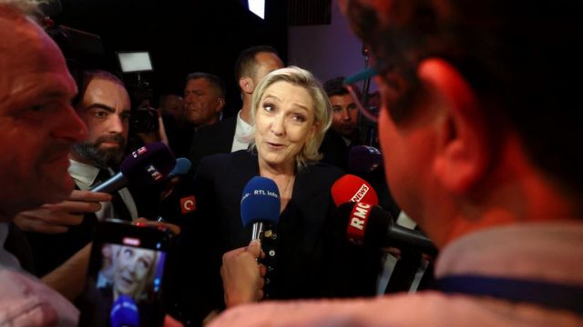 Marine Le Pen speaks with reporters