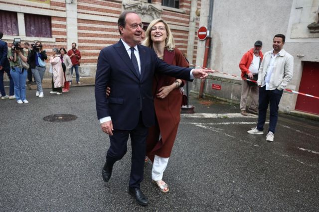 Francois Hollande, former French President and candidate for the left-wing political alliance called Nouveau Front Populaire (New Popular Front - NFP), and his wife Julie Gayet leave a polling station after voting in the first round of the early French parliamentary elections, in Tulle, France, on 30 June 2024