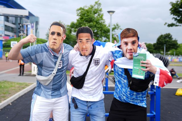 England fans wearing facemasks of Phil Foden, Jude Bellingham and Cole Palmer