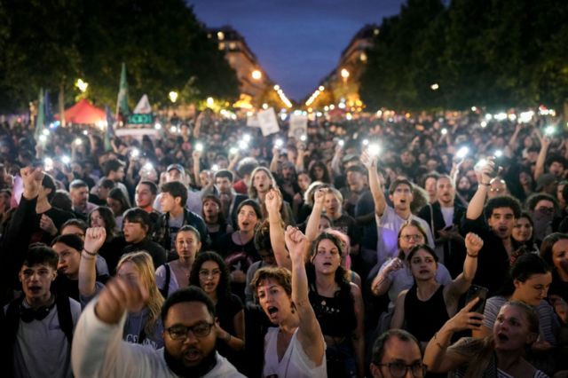 Demonstrators take part in a rally after the announcement of the results of the first round of French parliamentary elections, at Place de la Republique in Paris on 30 June 2024