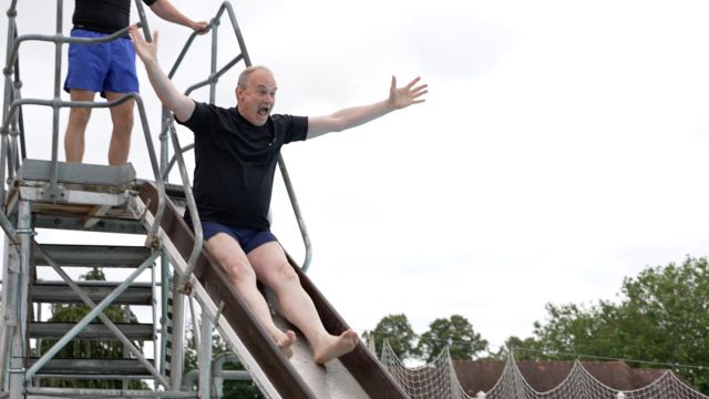 Sir Ed Davey on a waterslide at Sandford Parks Lido in Cheltenham
