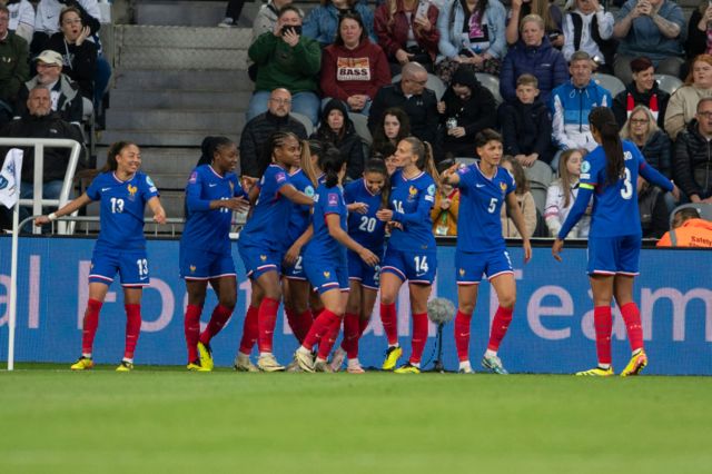 France celebrate after scoring against England at St James' Park
