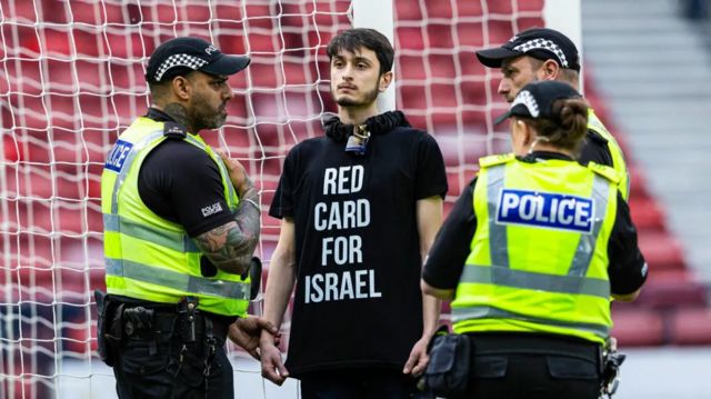 A protestor chained himself to the goalpost at Hampden on Friday