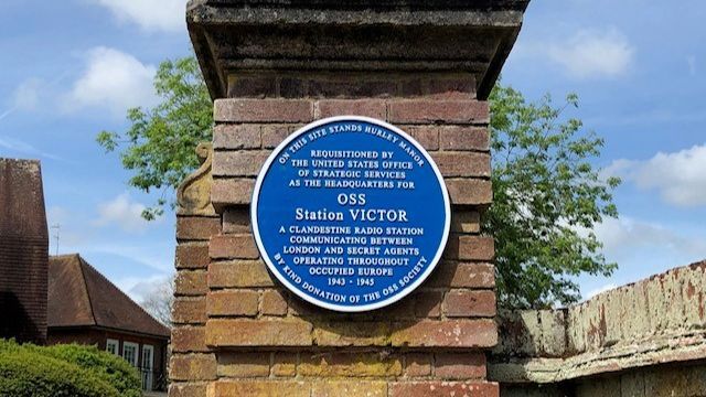 A blue plaque on the gate post at Station Victor to commemorate the work carried out there during World War Two