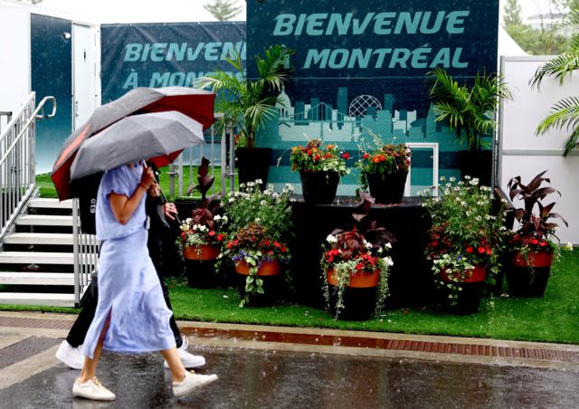 fans carry umbrellas as the rain falls in Montreal