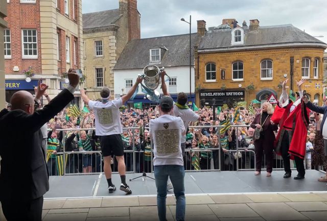 Northampton Saints players lift the Premiership trophy in front of fans
