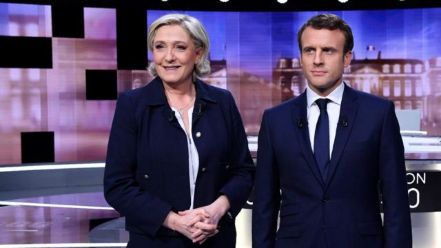 Marine Le Pen and Emmanuel Macron stand next to each other