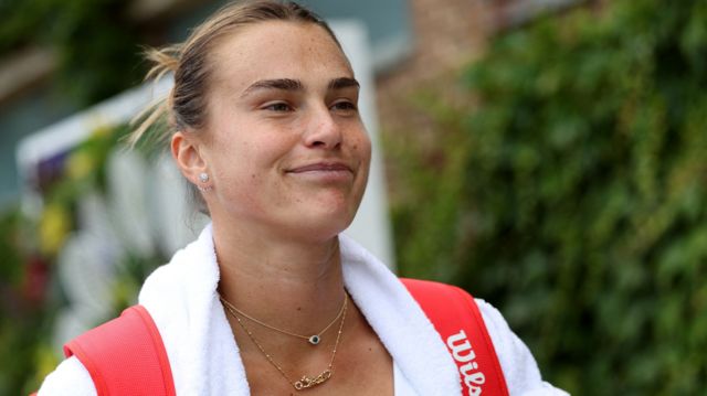 Aryna Sabalenka walks through Wimbledon