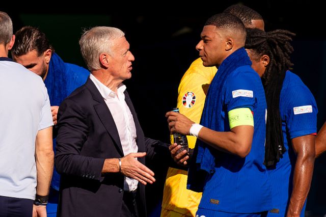 Coach Didier Deschamps of France interacts with Kylian Mbappe