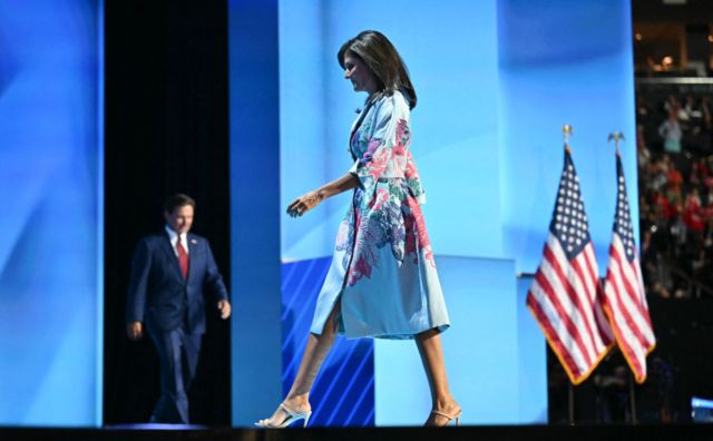 Nikki Haley walks across stage as Ron DeSantis arrives