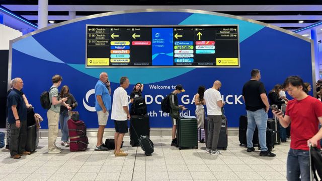 People wait in line at an airport