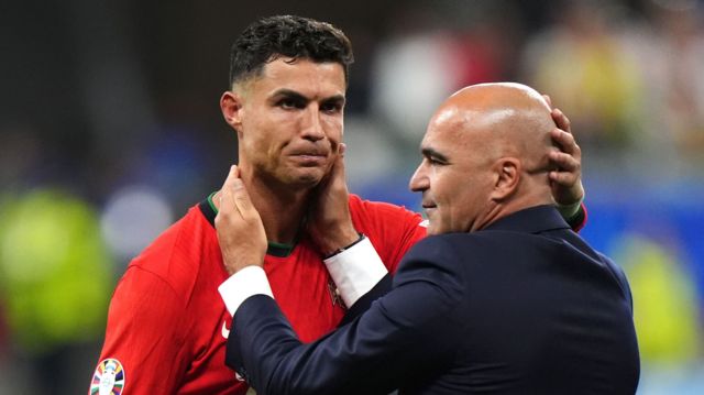 Cristiano Ronaldo is comforted by Portugal coach Roberto Martinez after their Euro 2024 win over Slovenia