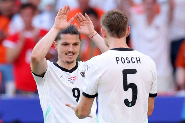 Marcel Sabitzer of Austria celebrates scoring his team's third goal with teammate Stefan Posch