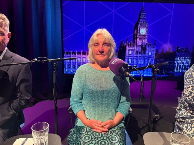 Green Party candidate for Whitehaven and Workington Jill Perry in the BBC Cumbria election debate studio wearing a fgeen top and patterned green and black skirt
