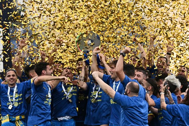 Venezia players lift the play-off trophy after winning promotion to Serie A